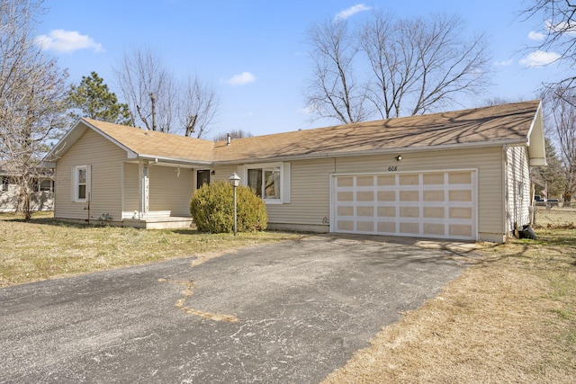 ranch-style home featuring driveway and an attached garage