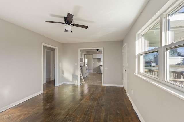 spare room with ceiling fan, hardwood / wood-style floors, and baseboards