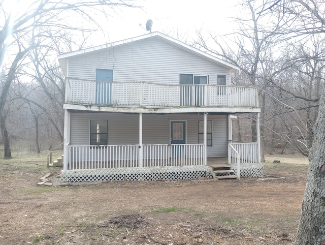 view of front of property featuring a porch and a balcony