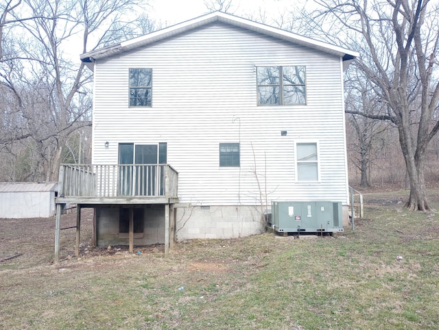 back of house with a yard and a wooden deck