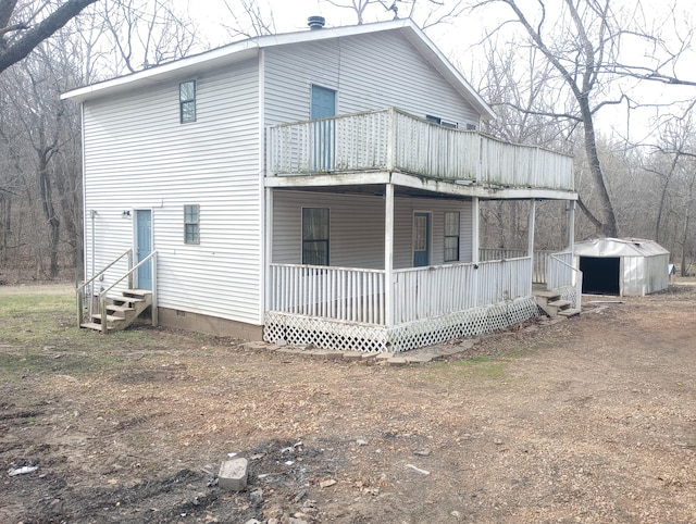 view of home's exterior with a porch, entry steps, crawl space, and a balcony