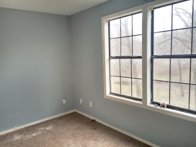 spare room with carpet floors and baseboards