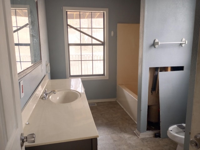 bathroom featuring a shower, visible vents, a healthy amount of sunlight, and vanity