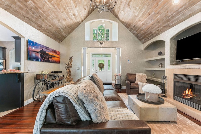 living room with wooden ceiling, built in features, wood finished floors, and a textured wall