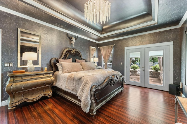 bedroom with access to exterior, french doors, wood-type flooring, a raised ceiling, and crown molding