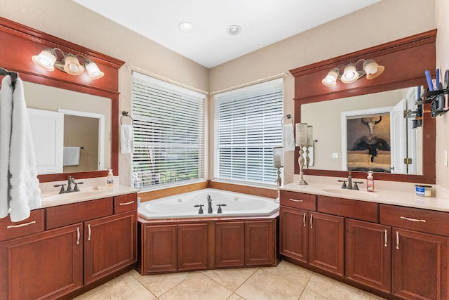 bathroom featuring two vanities, a sink, and a bath