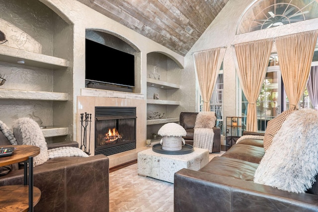 living room featuring built in features, wooden ceiling, high vaulted ceiling, and a lit fireplace