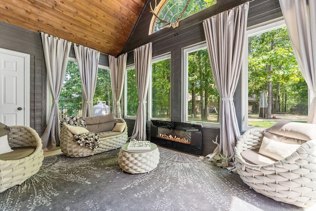 sunroom / solarium featuring vaulted ceiling and wood ceiling