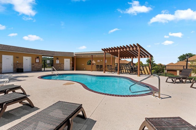 community pool with a patio area, fence, and a pergola