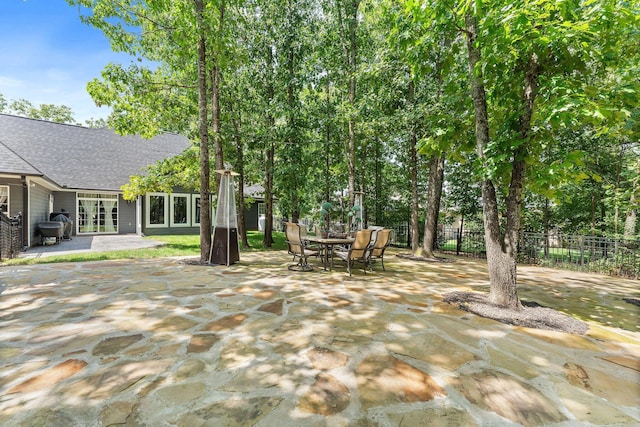 view of patio with fence and outdoor dining space