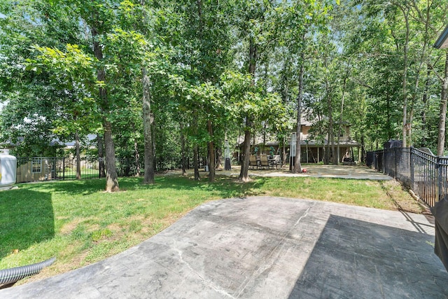 view of yard featuring fence and a patio