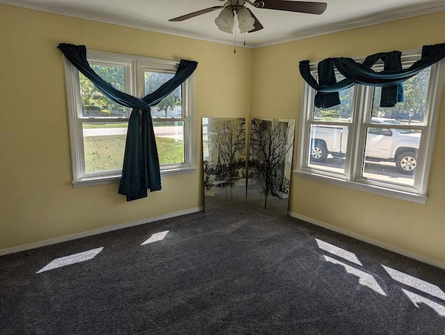 spare room with a ceiling fan, baseboards, ornamental molding, and carpet flooring