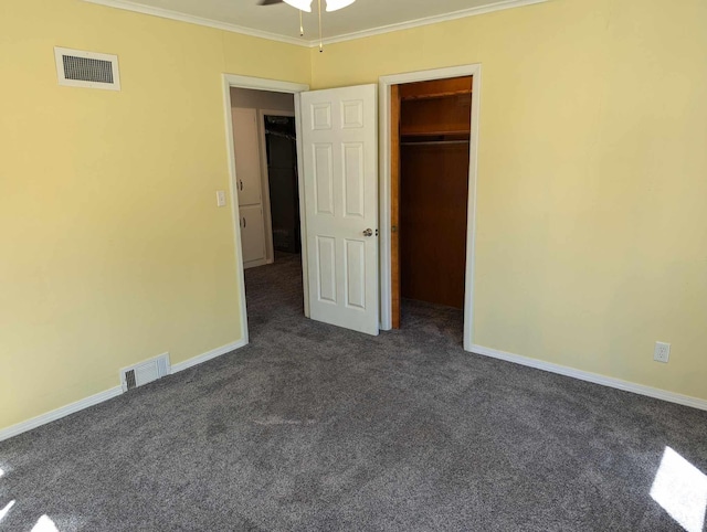 unfurnished bedroom featuring baseboards, visible vents, dark carpet, and ornamental molding