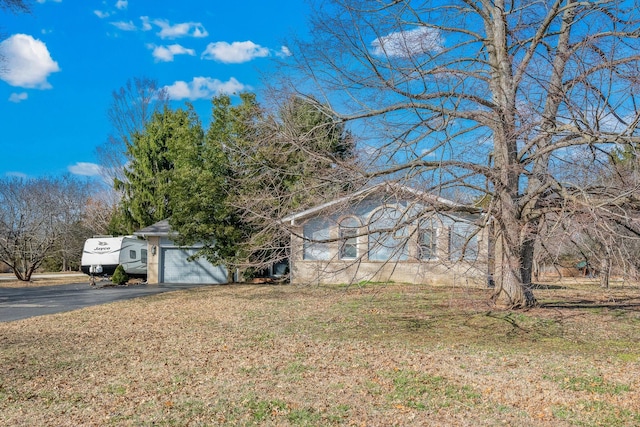 view of front of house featuring driveway and a front lawn