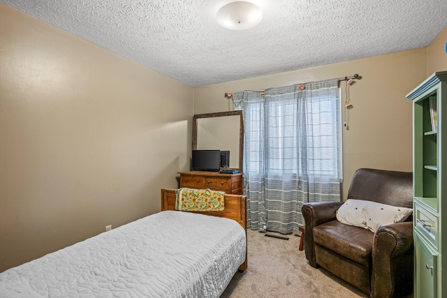 carpeted bedroom with a textured ceiling