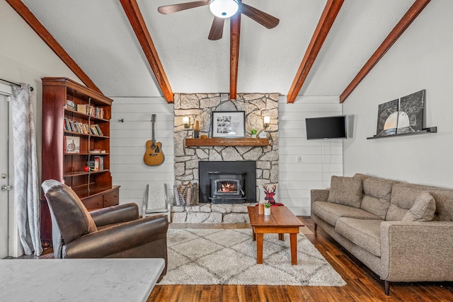 living room featuring ceiling fan, lofted ceiling with beams, a textured ceiling, and wood finished floors