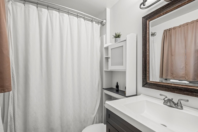 full bathroom with toilet, curtained shower, and vanity