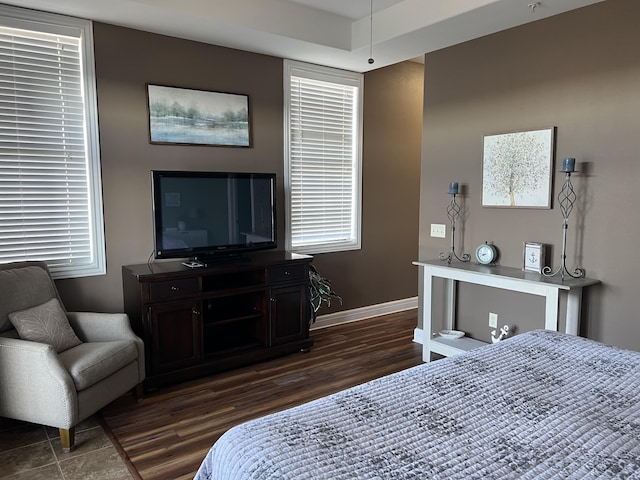 bedroom featuring dark wood-style floors and baseboards