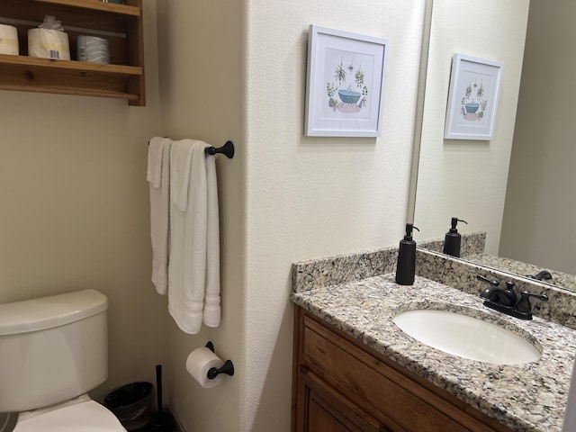 bathroom with toilet and vanity