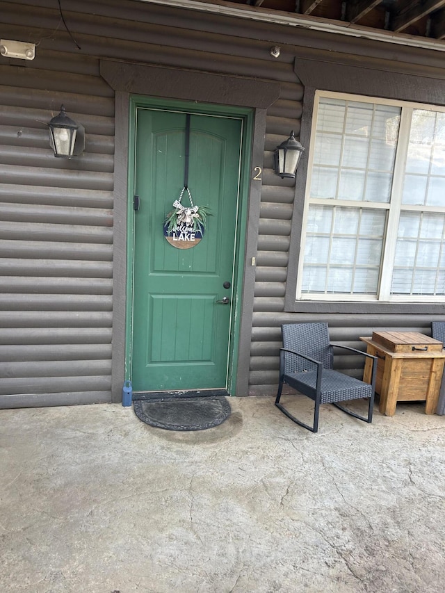 property entrance with faux log siding