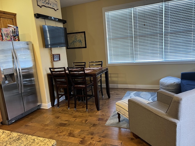 home office with baseboards and wood finished floors