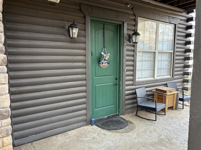 view of exterior entry with log siding