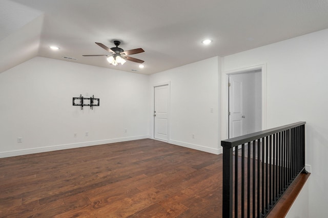 empty room featuring dark wood-style floors, recessed lighting, lofted ceiling, a ceiling fan, and baseboards