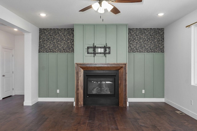 unfurnished living room with a glass covered fireplace, wainscoting, visible vents, and wallpapered walls