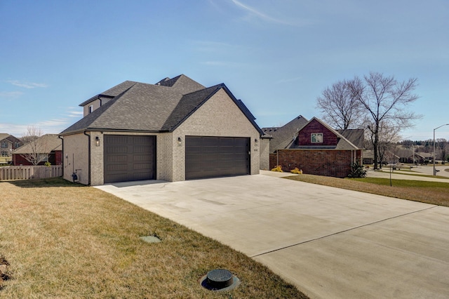 view of front of property with a garage, roof with shingles, fence, a front lawn, and brick siding