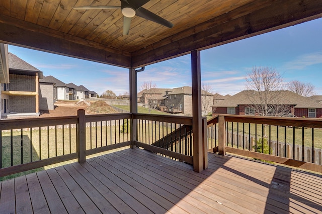 deck featuring a ceiling fan and a residential view