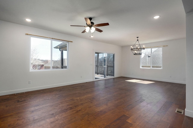 empty room with dark wood-type flooring, a wealth of natural light, baseboards, and recessed lighting