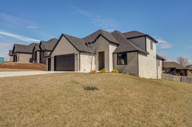 french country home featuring an attached garage, brick siding, fence, concrete driveway, and a front yard