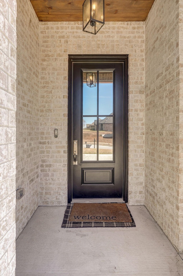 entrance to property with brick siding