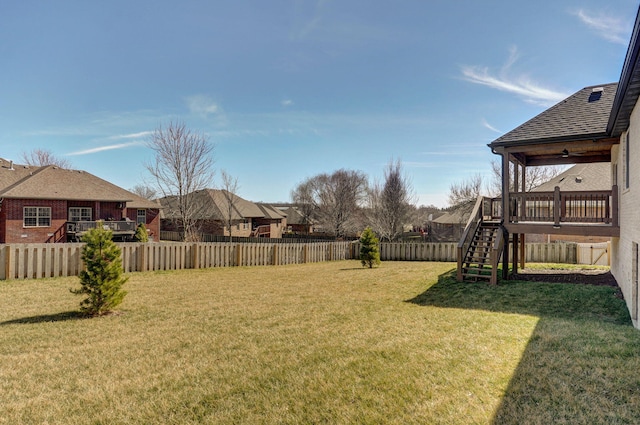 view of yard featuring a fenced backyard and stairs