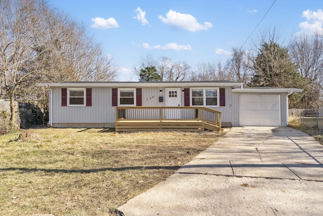 single story home featuring a front lawn, driveway, an attached garage, and fence