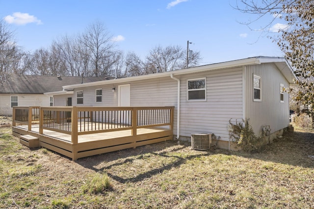 rear view of house with a wooden deck and central air condition unit