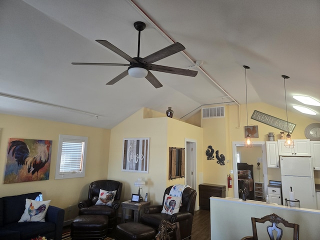 living area featuring dark wood-style floors, visible vents, vaulted ceiling, ceiling fan, and track lighting