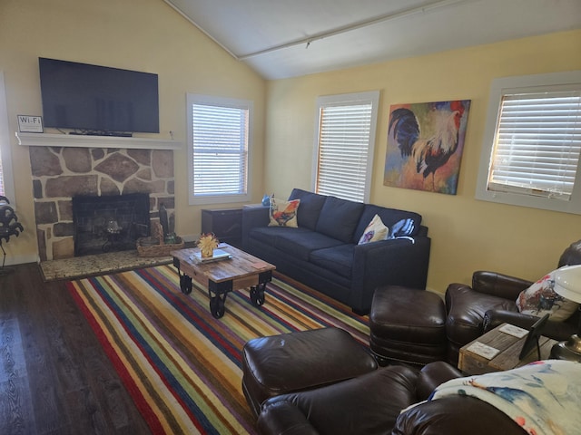 living area featuring lofted ceiling, a fireplace, and wood finished floors