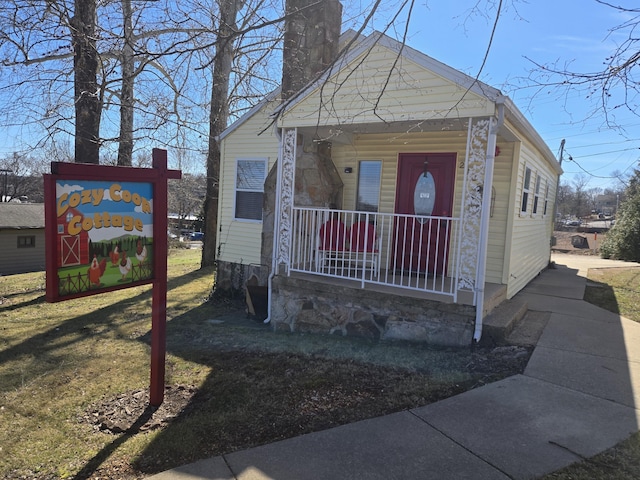 view of front of property featuring a porch and a chimney