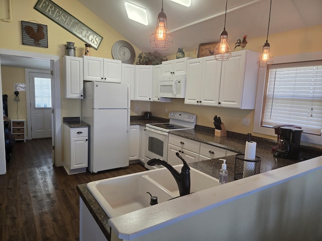 kitchen with pendant lighting, lofted ceiling, white appliances, and white cabinets