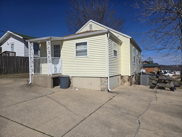 view of front of house with crawl space, fence, and central air condition unit