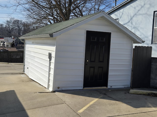 view of outdoor structure with an outbuilding and fence