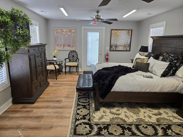 bedroom with light wood-type flooring, access to exterior, baseboards, and a ceiling fan