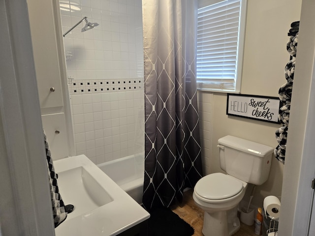 bathroom featuring shower / bath combo with shower curtain, wood finished floors, and toilet