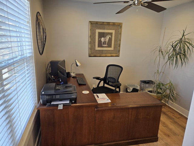 office space with a ceiling fan, baseboards, and wood finished floors