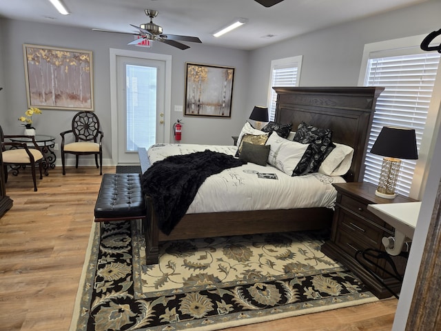 bedroom with light wood finished floors, access to outside, and ceiling fan