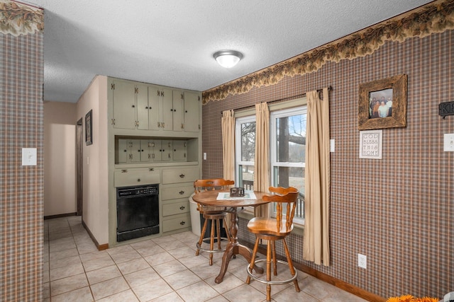 dining area with wallpapered walls, baseboards, a textured ceiling, and light tile patterned flooring