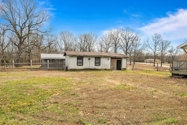 rear view of property with a yard and fence