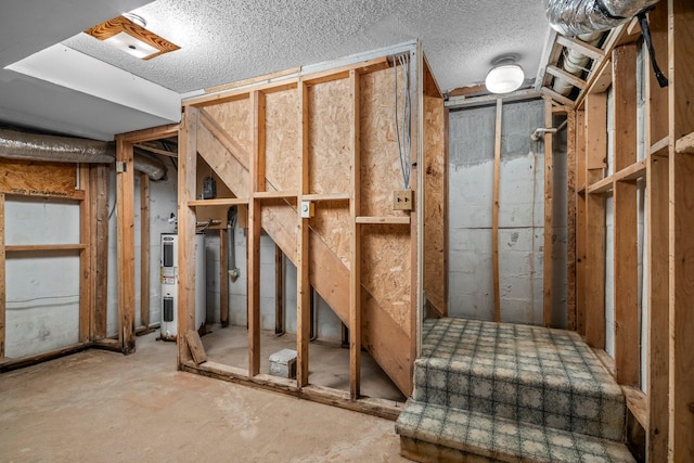 below grade area featuring heat pump water heater and a textured ceiling