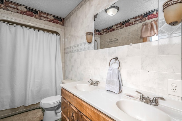 full bathroom featuring toilet, a textured ceiling, tile walls, and a sink